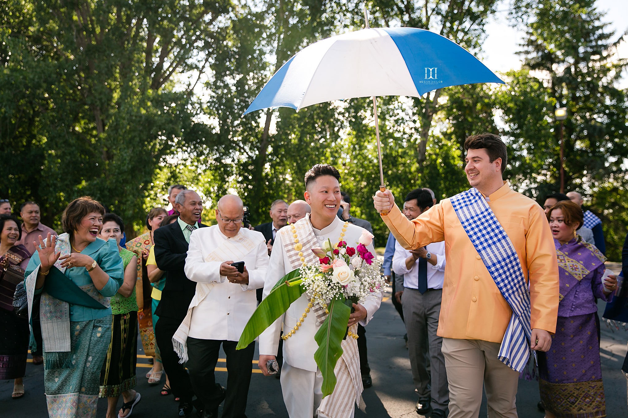 groom being escorted by joyful family and friends rochester photographers