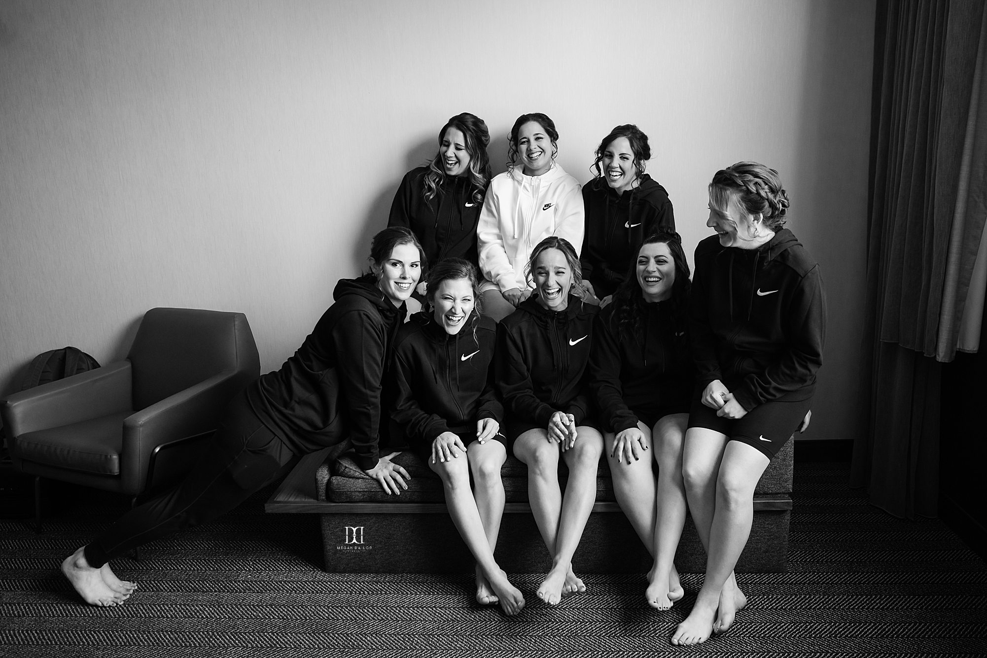 bride and bridesmaids laughing together on couch weddings at the highline