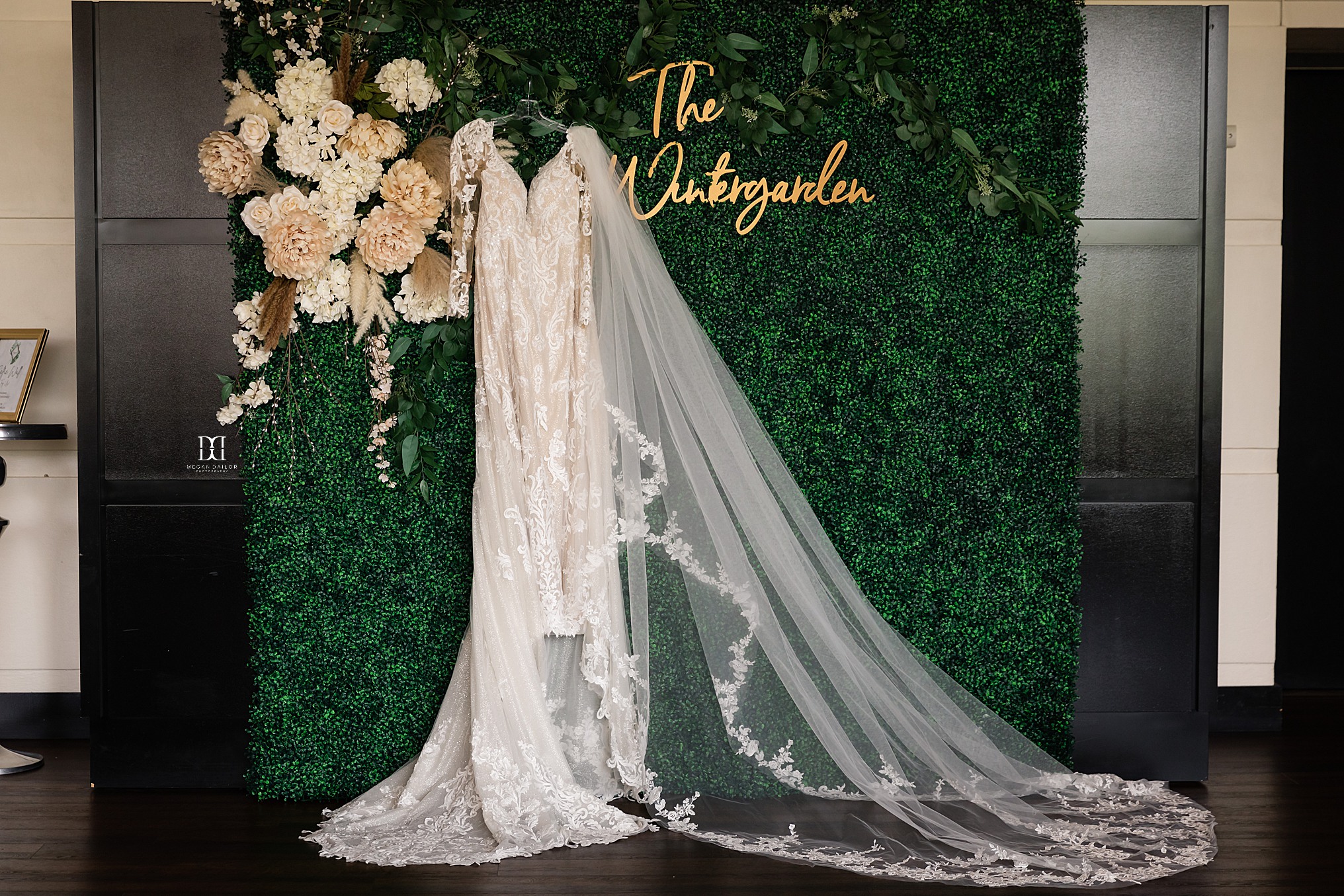 wedding dress hanging on photo wall at wintergarden