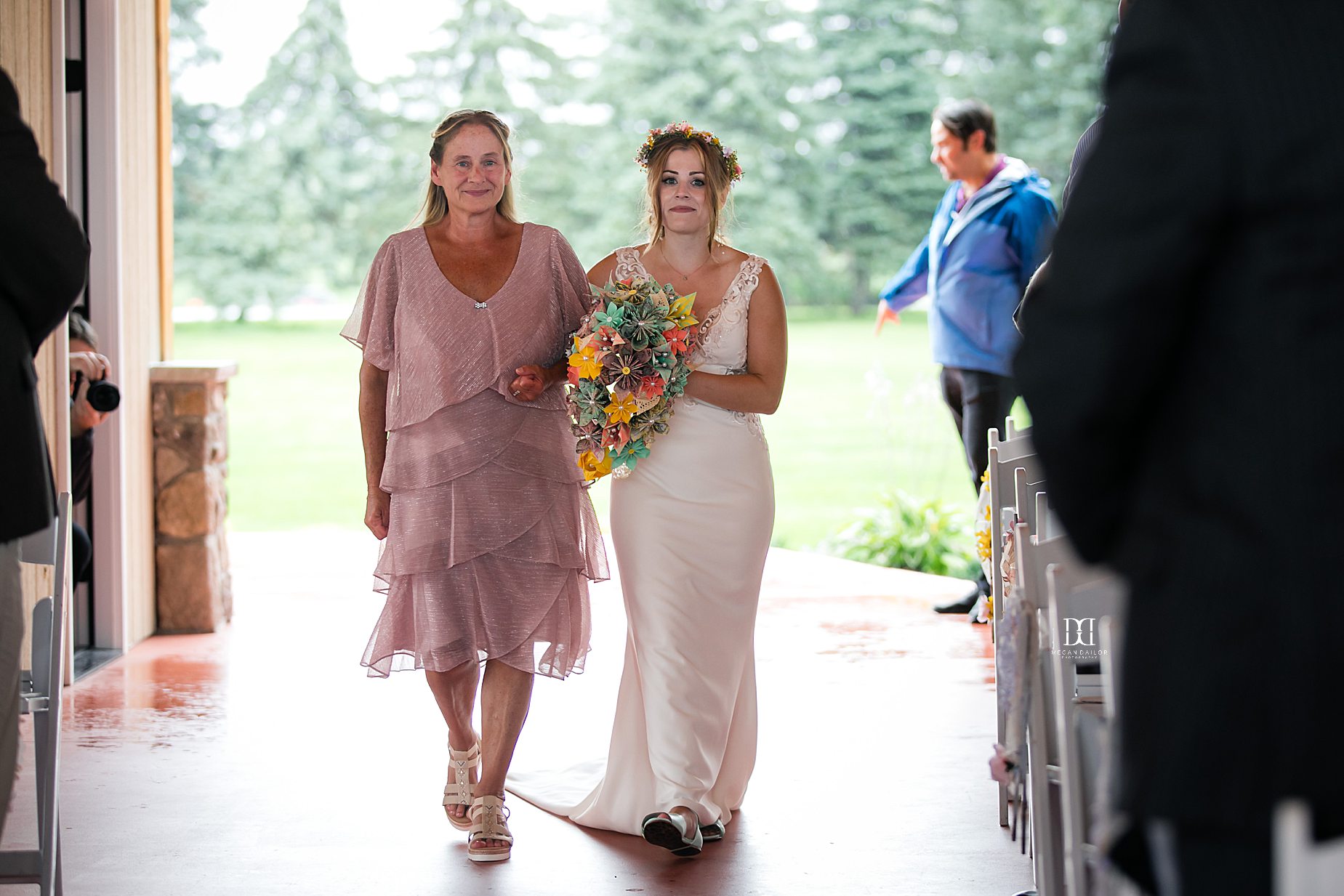 bride walking down the aisle with mother of bride
