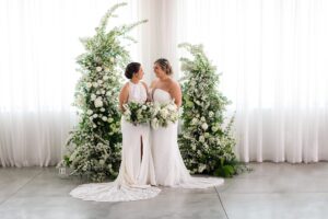 brides posing together at arbor weddings at the highline