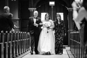 bride walking down the aisle with mother of bride and father of the bride. Syracuse wedding photographers
