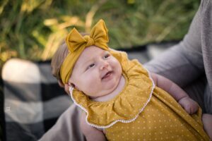 smiling baby yellow romper